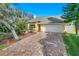 Charming, one-story home boasts a brick driveway, attached garage, and well-maintained landscaping at 72 Oceanview Ave, Ponce Inlet, FL 32127