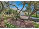 Charming front exterior with brick driveway, tropical foliage, and two car garage at 72 Oceanview Ave, Ponce Inlet, FL 32127