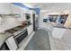 Well-lit kitchen featuring stainless steel appliances, white cabinetry, and tiled backsplash with gas range at 72 Oceanview Ave, Ponce Inlet, FL 32127