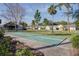 Community shuffleboard courts in landscaped common area with palm trees and benches at 731 Pine Shores Cir, New Smyrna Beach, FL 32168
