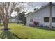 Well-maintained lawn and landscaping adorns this light colored home with two windows and a sign at 731 Pine Shores Cir, New Smyrna Beach, FL 32168