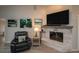 Comfortable living room features a brick fireplace with flatscreen TV and coastal decor at 731 Pine Shores Cir, New Smyrna Beach, FL 32168