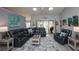 Bright living room with coastal decor, large sectional sofa, and sliding glass doors at 731 Pine Shores Cir, New Smyrna Beach, FL 32168