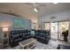 Living room with large sectional, sliding glass doors, and view of adjacent rooms at 731 Pine Shores Cir, New Smyrna Beach, FL 32168
