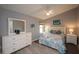 Relaxing main bedroom featuring a ceiling fan, en suite bathroom and calming gray walls at 731 Pine Shores Cir, New Smyrna Beach, FL 32168