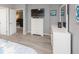 Comfortable bedroom features a large dresser, television and decorative accessories for a restful retreat at 731 Pine Shores Cir, New Smyrna Beach, FL 32168