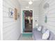 Cozy sun room entrance with comfortable seating and nautical decorations at 731 Pine Shores Cir, New Smyrna Beach, FL 32168