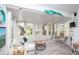 Cozy sun room featuring neutral tones, bright white trim and several windows and a sliding glass door at 731 Pine Shores Cir, New Smyrna Beach, FL 32168