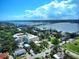 Expansive aerial shot showcasing a neighborhood with waterfront views, bridges, and diverse housing options under a blue sky at 746 N Halifax Ave, Daytona Beach, FL 32118