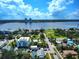 Breathtaking aerial view overlooking a serene body of water, lush greenery, and charming residential buildings under a blue sky at 746 N Halifax Ave, Daytona Beach, FL 32118