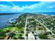 Panoramic aerial showcasing tree-lined streets, diverse housing options, a coastline, and a distant skyline at 746 N Halifax Ave, Daytona Beach, FL 32118