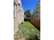 Backyard with a green grass area, wood fence, and a clear blue sky at 746 N Halifax Ave, Daytona Beach, FL 32118