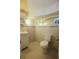 Bathroom featuring a toilet, sink, and decorative wall mirror at 746 N Halifax Ave, Daytona Beach, FL 32118