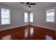 Bright bedroom with refinished hardwood floors and three windows at 746 N Halifax Ave, Daytona Beach, FL 32118