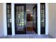 Beautiful entryway with double doors and a view into a living room featuring a stone fireplace at 746 N Halifax Ave, Daytona Beach, FL 32118