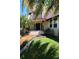 Elegant home with decorative tile steps, red-tiled accents, and lush, manicured landscaping at 746 N Halifax Ave, Daytona Beach, FL 32118