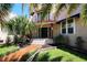 Stunning home entrance with decorative tile steps, a red tile roof, and manicured landscaping at 746 N Halifax Ave, Daytona Beach, FL 32118