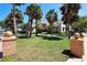 Inviting home with lush landscaping, a red tile roof, and mature palm trees lining the front yard at 746 N Halifax Ave, Daytona Beach, FL 32118