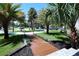 Charming front yard with lush landscaping, palm trees, and a welcoming walkway at 746 N Halifax Ave, Daytona Beach, FL 32118