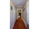 Hallway featuring gleaming wood floors and built-in storage at 746 N Halifax Ave, Daytona Beach, FL 32118