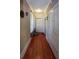 Hallway with hardwood floors, textured walls, and a storage cabinet at 746 N Halifax Ave, Daytona Beach, FL 32118