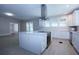 Bright kitchen features white cabinets, stainless steel appliances and large center island at 746 N Halifax Ave, Daytona Beach, FL 32118
