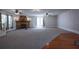 Spacious living room featuring a stone fireplace, carpet, and staircase at 746 N Halifax Ave, Daytona Beach, FL 32118
