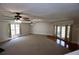 Large living room featuring carpet, hardwood floors, a fireplace, and access to the outdoors at 746 N Halifax Ave, Daytona Beach, FL 32118