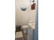 Small, stylish bathroom featuring a round ocean themed art piece and decor at 835 E 24Th Ave # 111, New Smyrna Beach, FL 32169