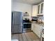 Efficient kitchen featuring stainless steel appliances, white cabinets, and granite countertops at 835 E 24Th Ave # 111, New Smyrna Beach, FL 32169
