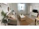 Open-concept living space with couch, area rug and entertainment center with mounted TV at 835 E 24Th Ave # 111, New Smyrna Beach, FL 32169