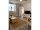 Inviting living room with wood-look flooring, jute rug, and an entertainment center at 835 E 24Th Ave # 111, New Smyrna Beach, FL 32169