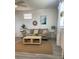 Relaxing living room with neutral sofa, jute rug, and bright natural light from the window at 835 E 24Th Ave # 111, New Smyrna Beach, FL 32169