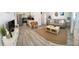 Open living space with living room and kitchen featuring stylish furniture and stainless steel appliances at 835 E 24Th Ave # 111, New Smyrna Beach, FL 32169