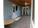 Inviting screened-in back porch with wood ceiling, ceiling fans, a porch swing, and room to gather at 855 Sugar House Dr, Port Orange, FL 32129