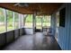 Spacious screened-in back porch features ceiling fans, wood ceiling, a porch swing and plenty of space at 855 Sugar House Dr, Port Orange, FL 32129