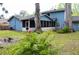 A view of the backyard and the house with the screened in back porch at 855 Sugar House Dr, Port Orange, FL 32129
