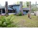 View of backyard and blue two story house. Lush garden is featured in the foreground at 855 Sugar House Dr, Port Orange, FL 32129
