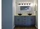 A modern bathroom with dual vessel sinks, gray cabinets, and a large mirror at 855 Sugar House Dr, Port Orange, FL 32129