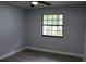 Neutral bedroom featuring tile floors and a new window at 855 Sugar House Dr, Port Orange, FL 32129