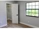 Bedroom featuring wood-look tile flooring, a closet and lots of natural light at 855 Sugar House Dr, Port Orange, FL 32129