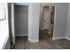 Bedroom featuring wood-look tile flooring, a built-in closet, and plenty of natural light at 855 Sugar House Dr, Port Orange, FL 32129