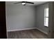 Bedroom featuring a ceiling fan, wood-look flooring, and natural lighting at 855 Sugar House Dr, Port Orange, FL 32129