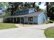 Charming home features blue siding, a well-manicured lawn, and a paved driveway leading to an attached garage at 855 Sugar House Dr, Port Orange, FL 32129