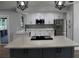 Bright kitchen with white cabinets, gray backsplash, a stainless steel fridge and a large island with cooktop at 855 Sugar House Dr, Port Orange, FL 32129