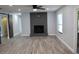 Cozy living room featuring a sleek fireplace, wood-look floors, and stylish barn doors at 855 Sugar House Dr, Port Orange, FL 32129