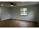 A spacious living area with natural light from a large window and wood-look flooring at 855 Sugar House Dr, Port Orange, FL 32129