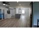 Inviting open-concept layout with wood-look floors, bright white kitchen, dining area and stylish barn doors at 855 Sugar House Dr, Port Orange, FL 32129