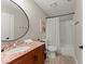 This bathroom features granite countertops, a shower/tub combo and a decorative mirror at 898 Baybreeze Way # 880, New Smyrna Beach, FL 32169