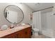 Bathroom featuring granite countertops, a shower/tub combo and a decorative mirror at 898 Baybreeze Way # 880, New Smyrna Beach, FL 32169